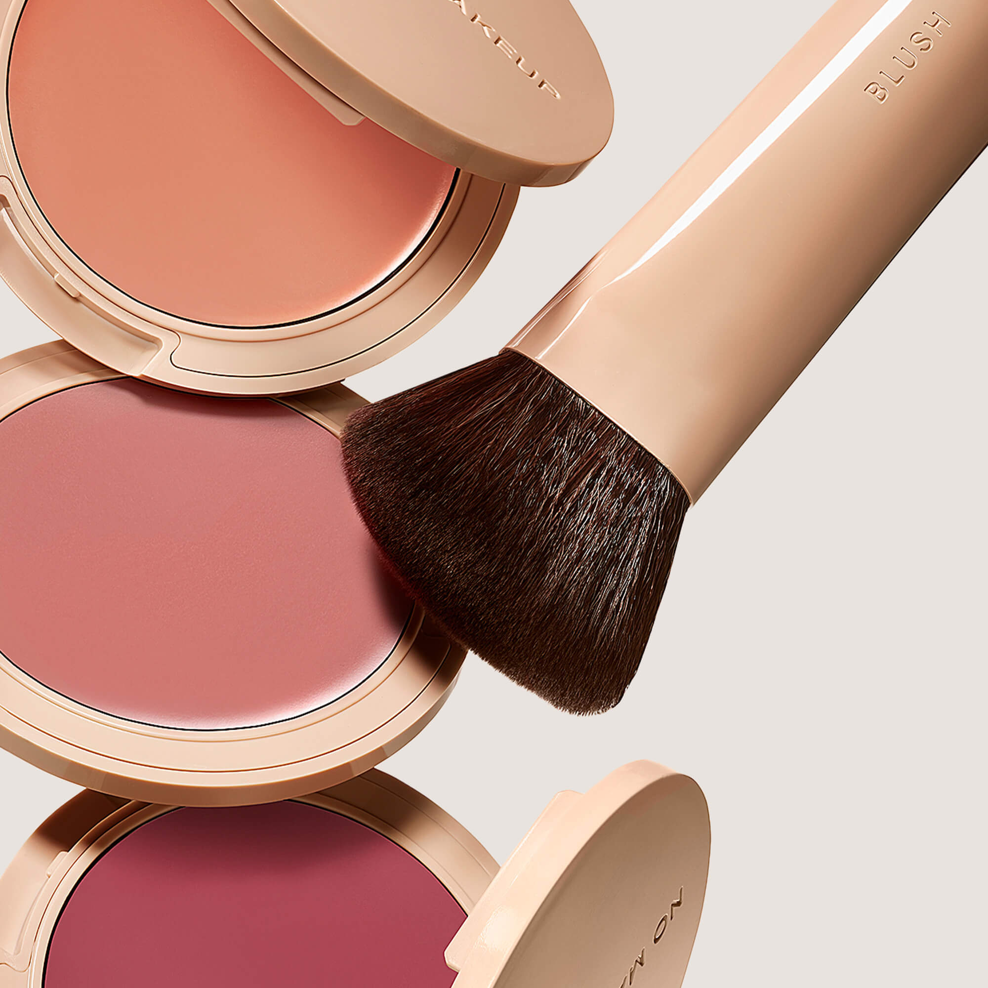 peach, pink, and plum blush shades with a brush
