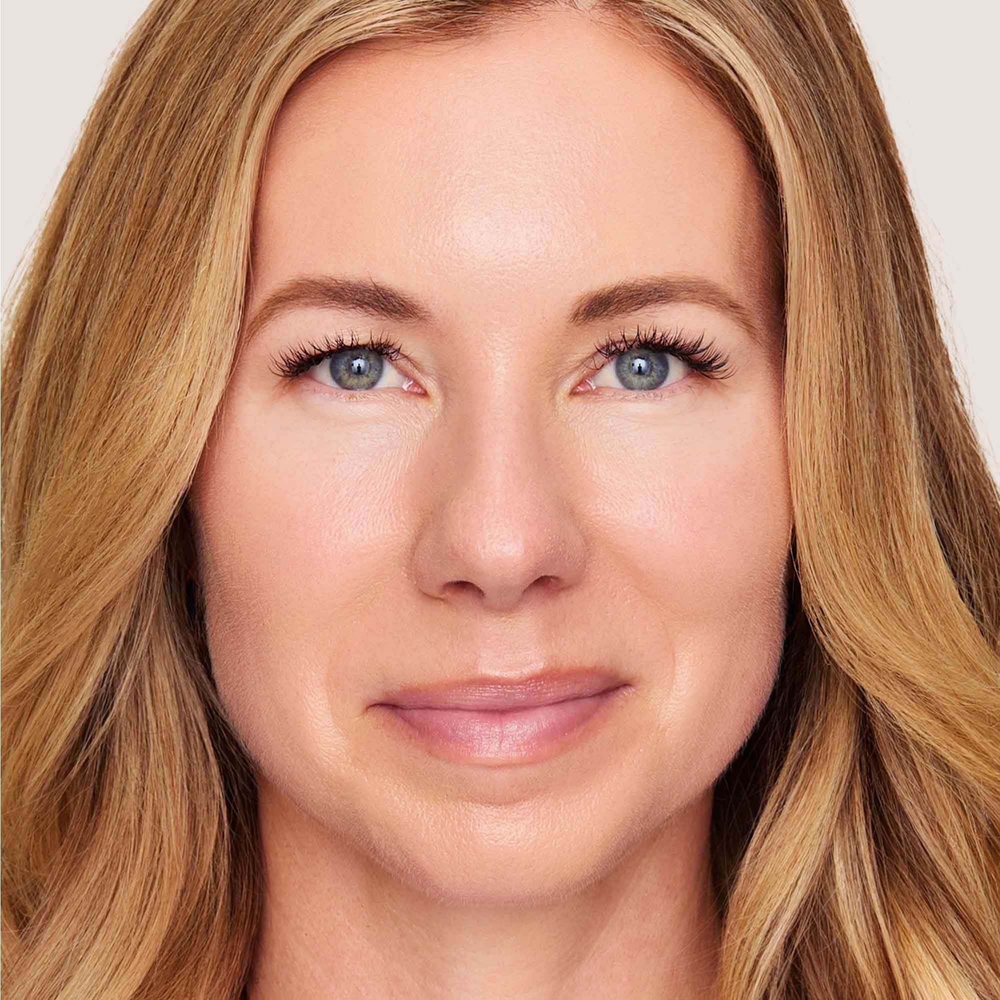 An image of a woman wearing FlexShade Foundation by No Makeup Makeup in Light Medium