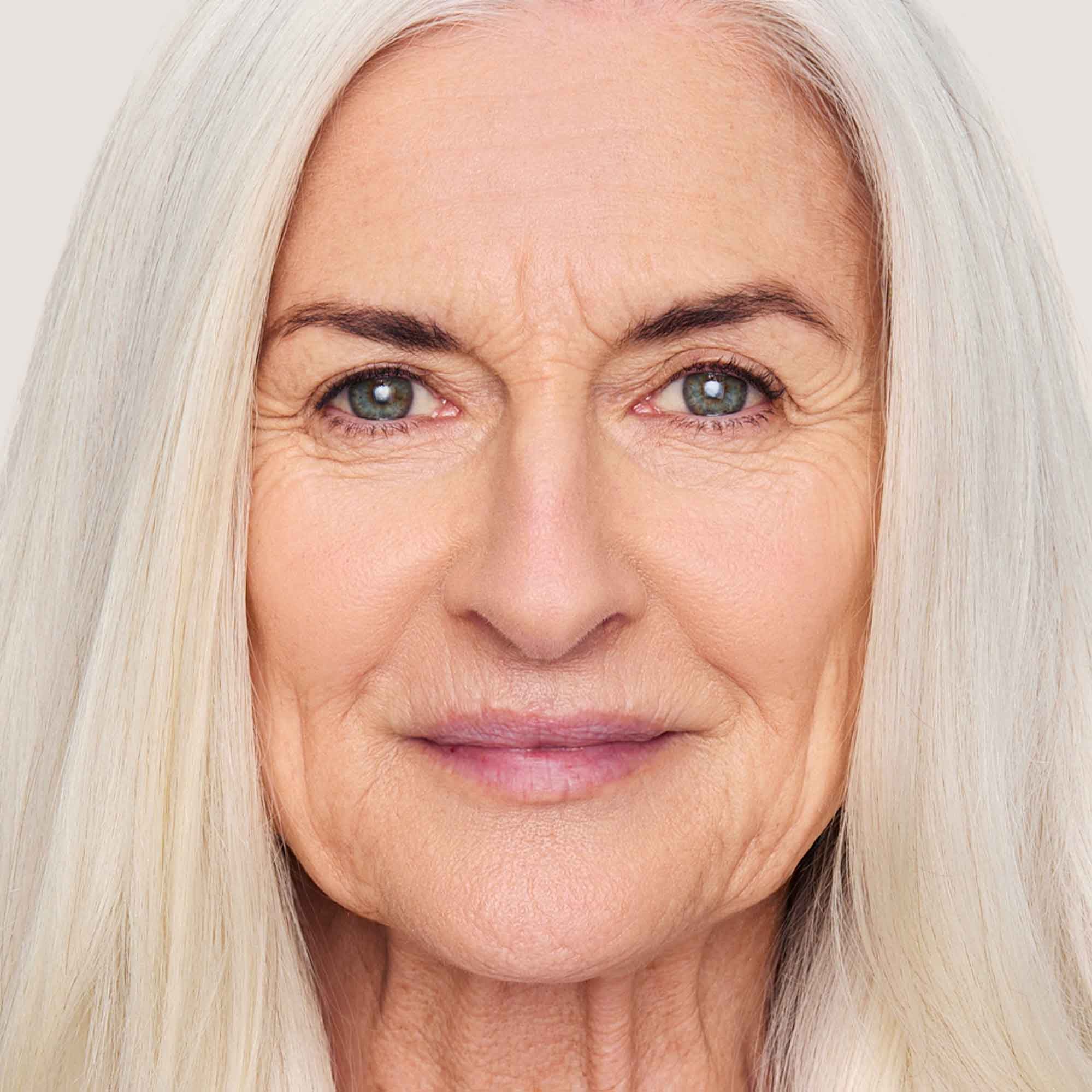 An image of a woman wearing FlexShade Foundation by No Makeup Makeup in Light Medium