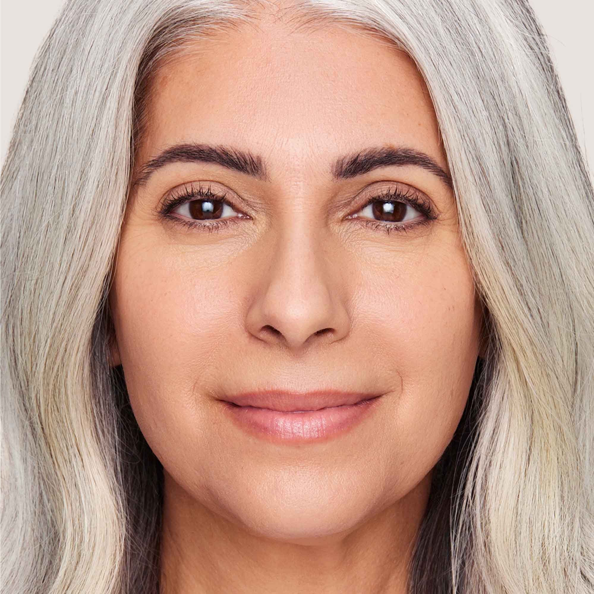 An image of a woman wearing FlexShade Foundation by No Makeup Makeup in Light Medium