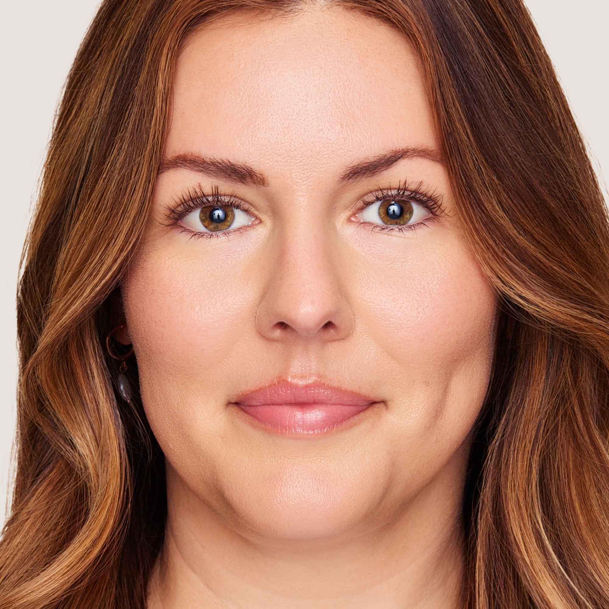 An image of a woman wearing FlexShade Foundation by No Makeup Makeup in Light Medium