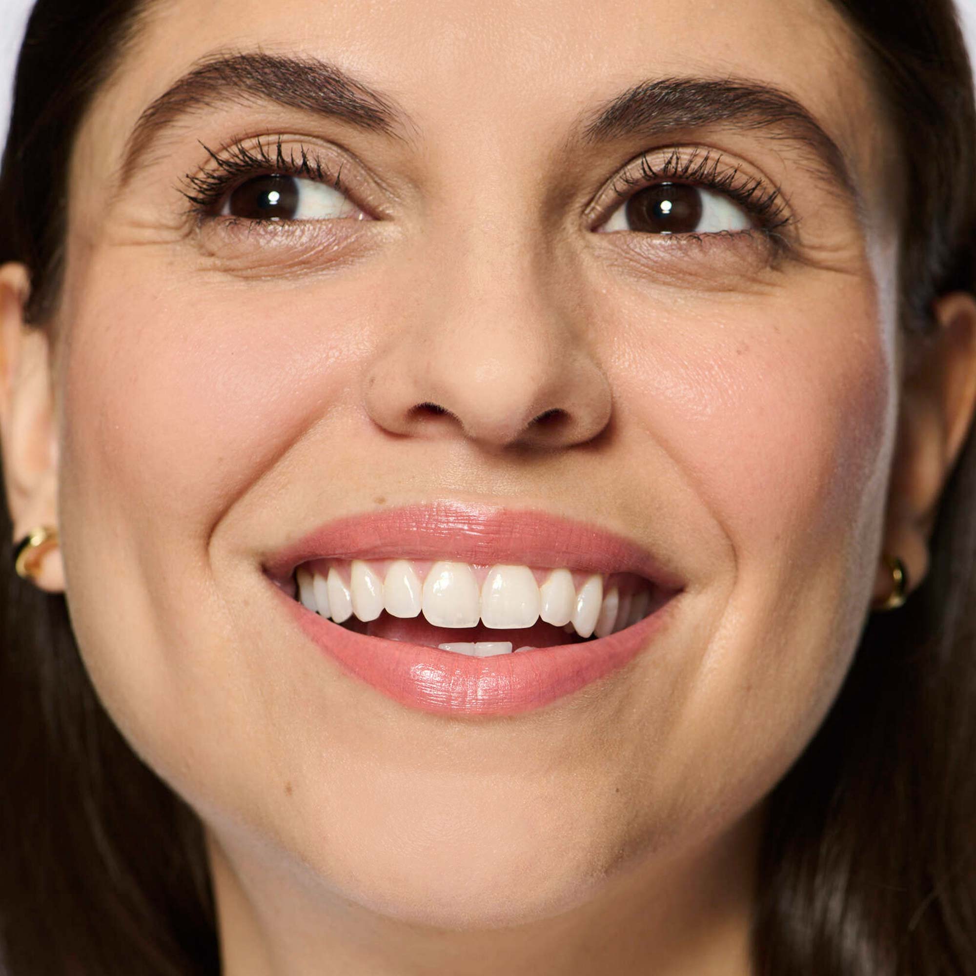 light medium skin model wearing pink 01 lipstick shade smiling