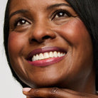 dark skin model wearing plum 01 lipstick shade