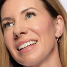 Close-up of a light medium skin toned woman wearing pink blush on cheeks and lips