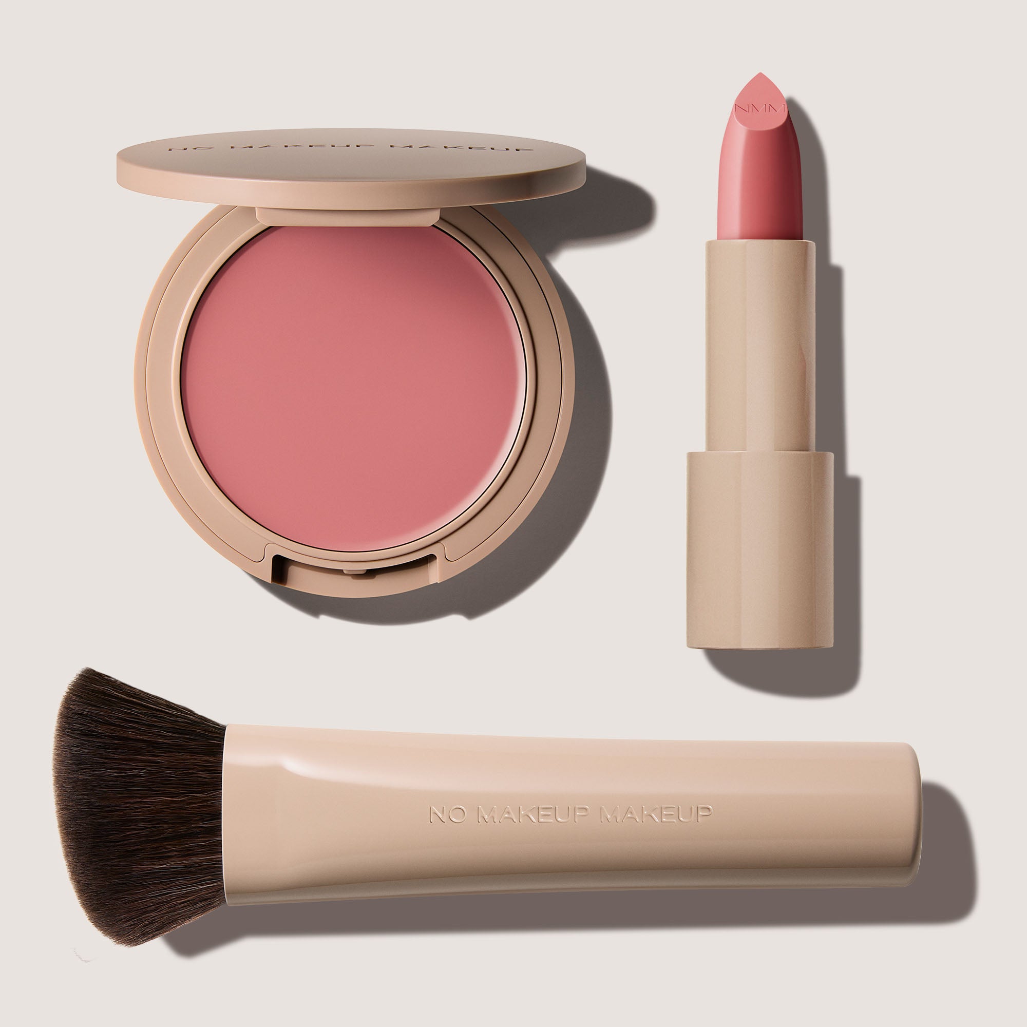No Makeup Makeup – Makeup set with nude rose blush & lip color, nude rose Creme Classic Lipstick, and brush on a light background, natural minimal makeup