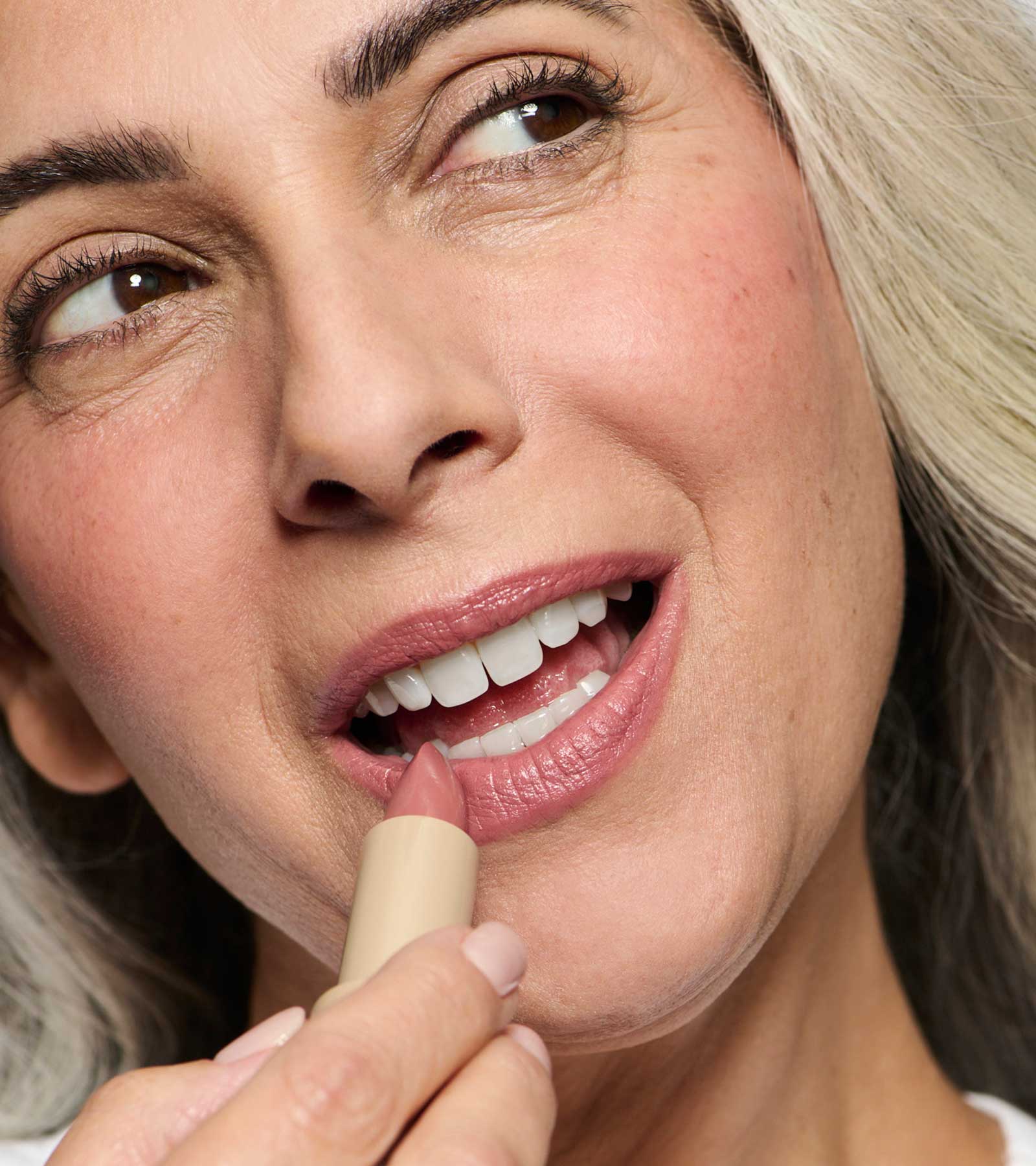model wearing and holding pink 02 lipstick shade