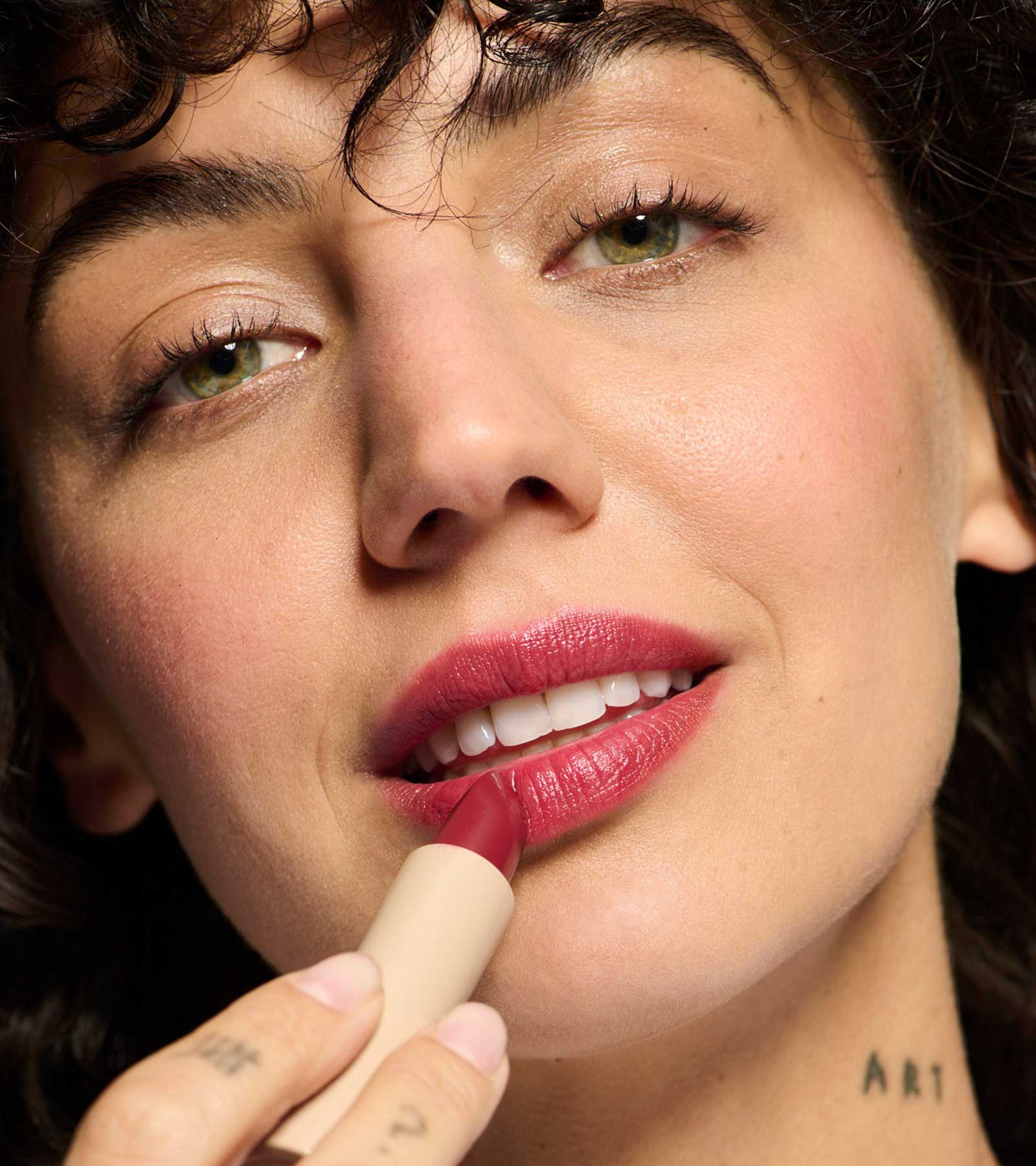 model wearing and holding plum 02 lipstick shade