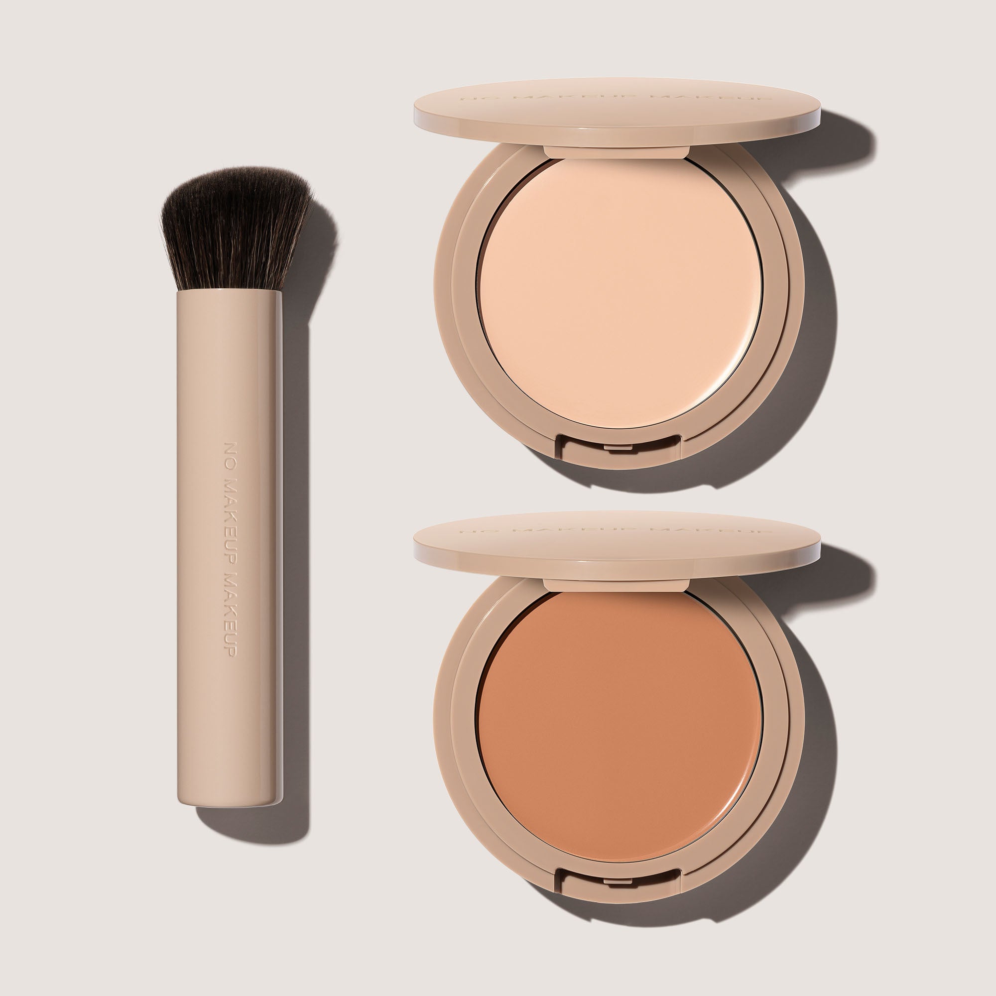 Two FlexShade Foundation by No Makeup Makeups and a brush and an Oprah Daily awards seal