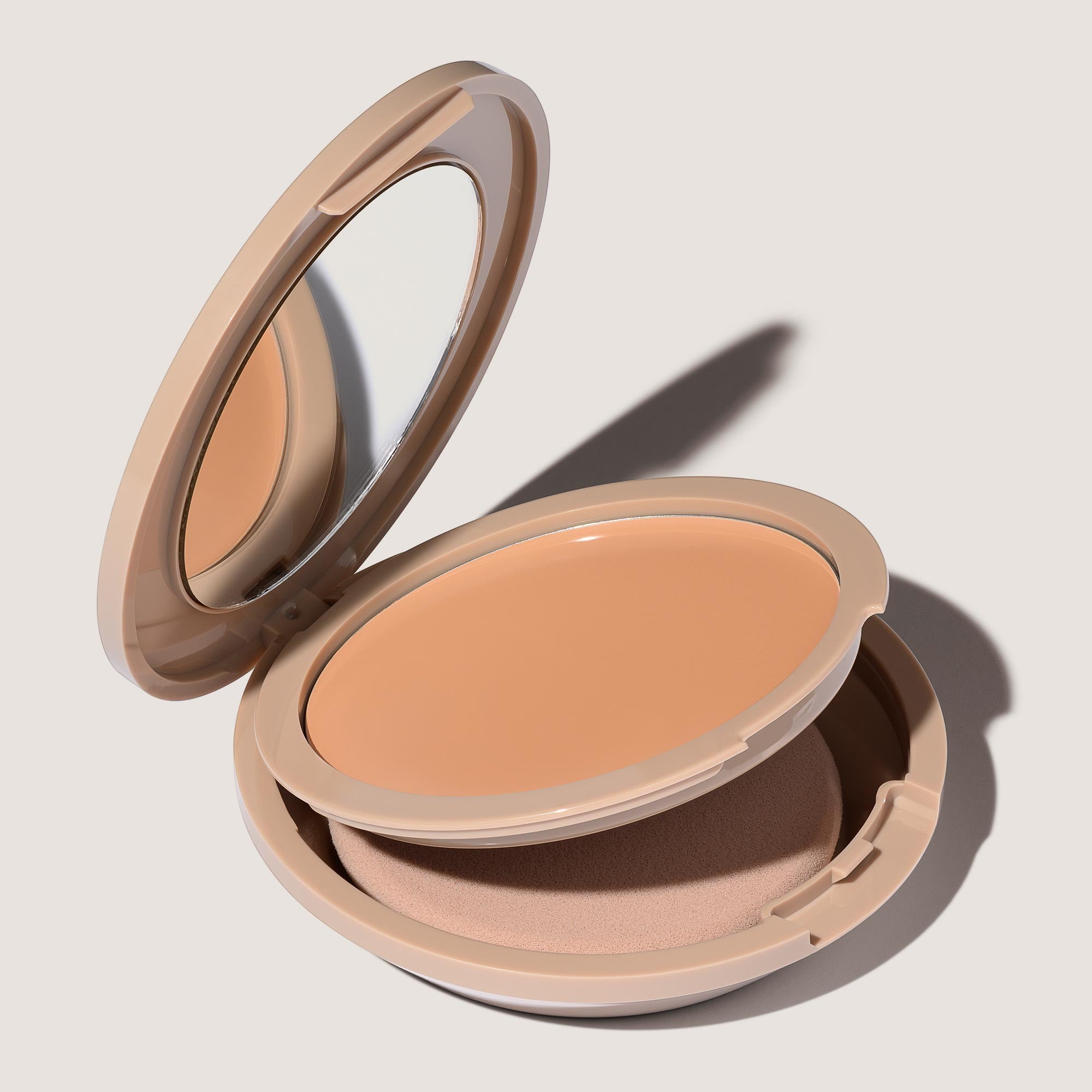 An open FlexShade Foundation by No Makeup Makeup compact in Light Medium showing the sponge compartment