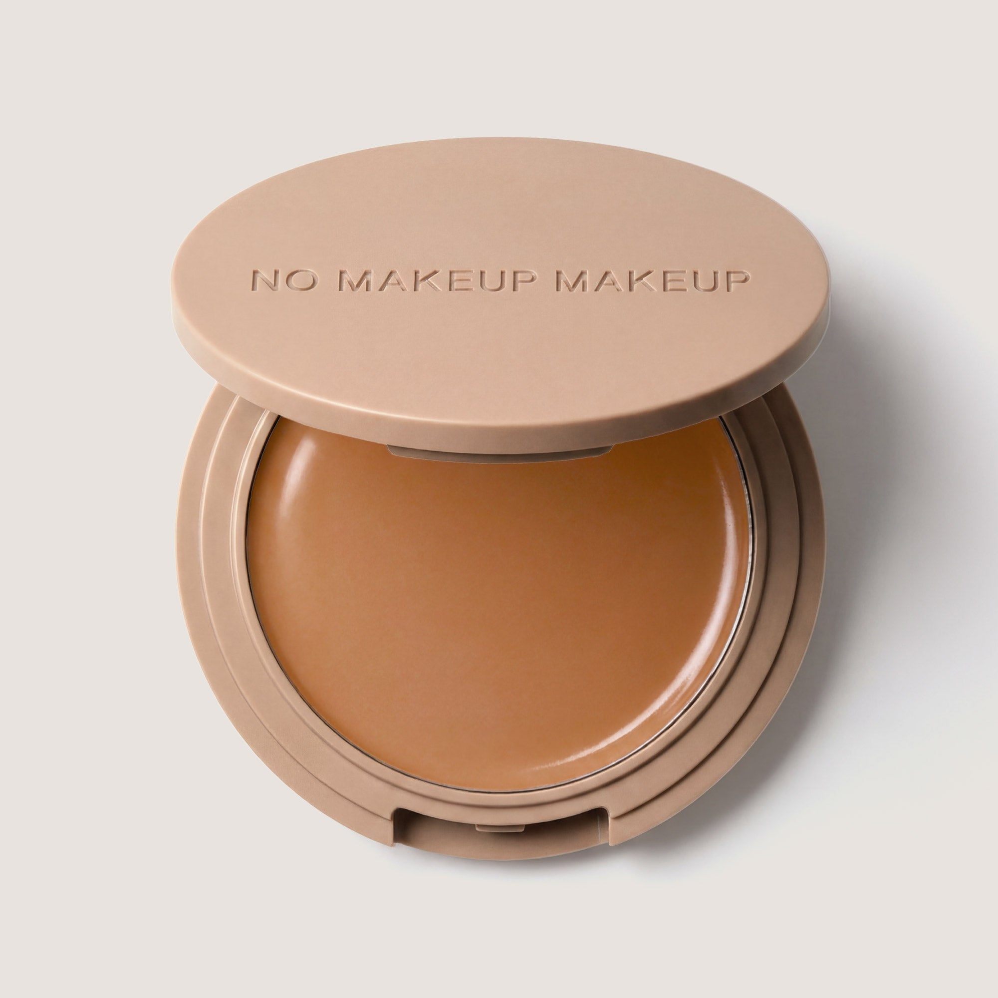 An open FlexShade Foundation by No Makeup Makeup compact in Tan with the Oprah Daily Beauty O-Wards 2024 seal