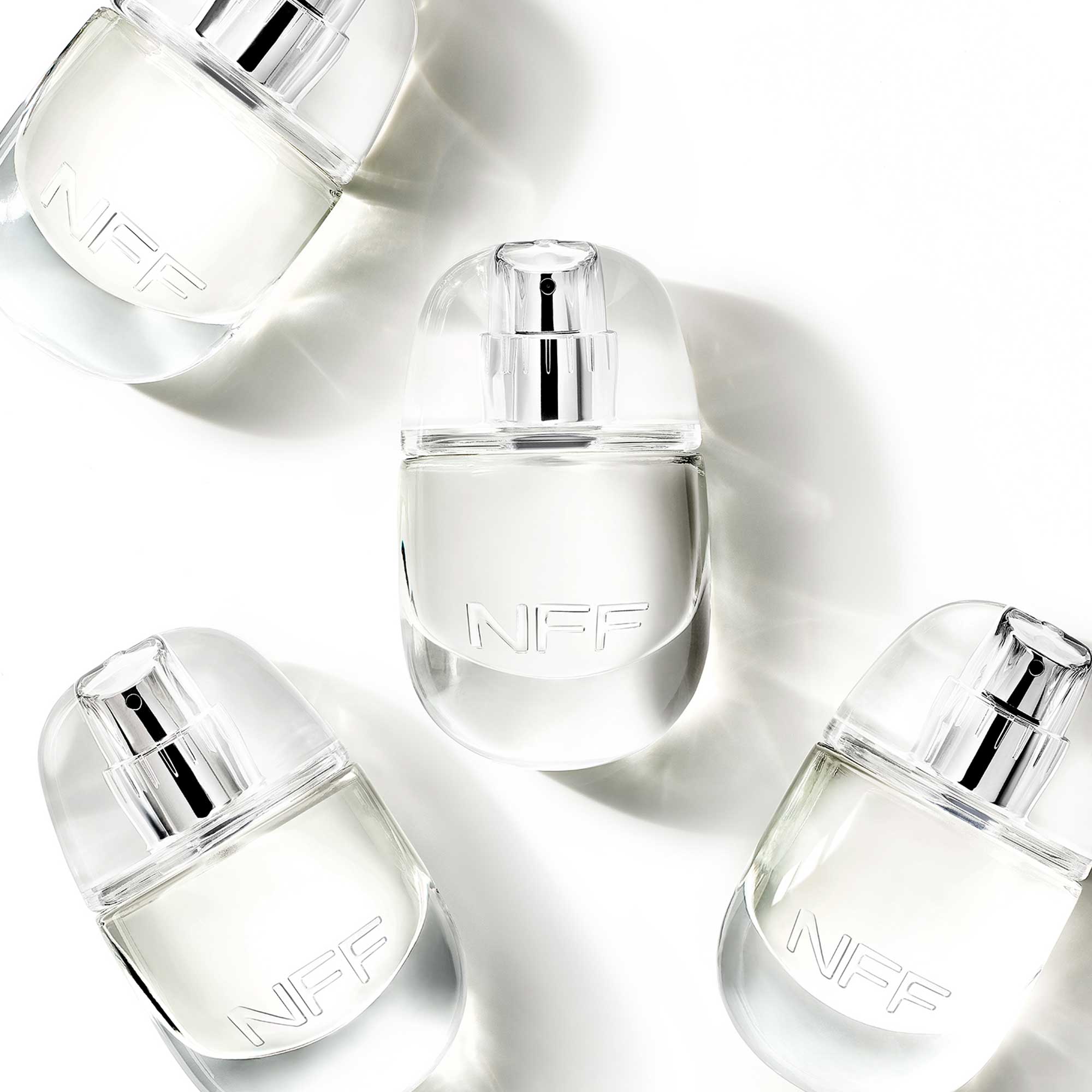 Clear perfume bottles on a white background