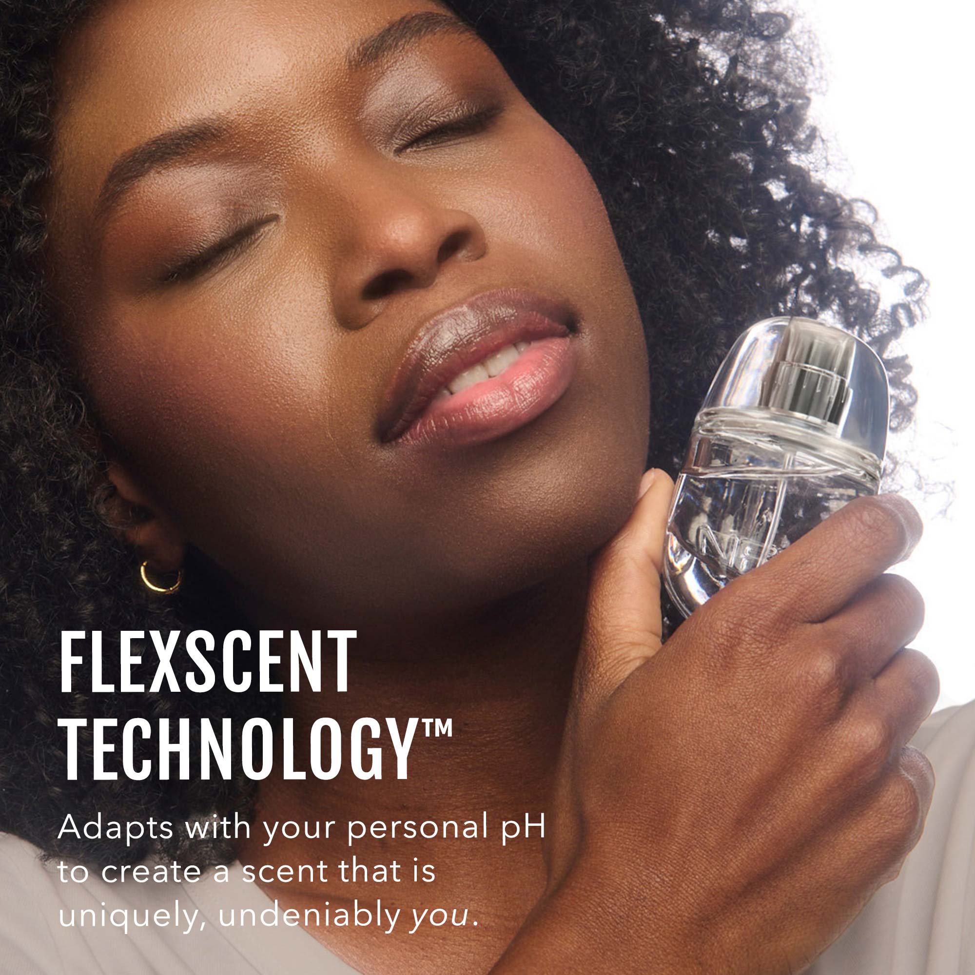 Woman holding a perfume bottle with 'FlexScent Technology' text