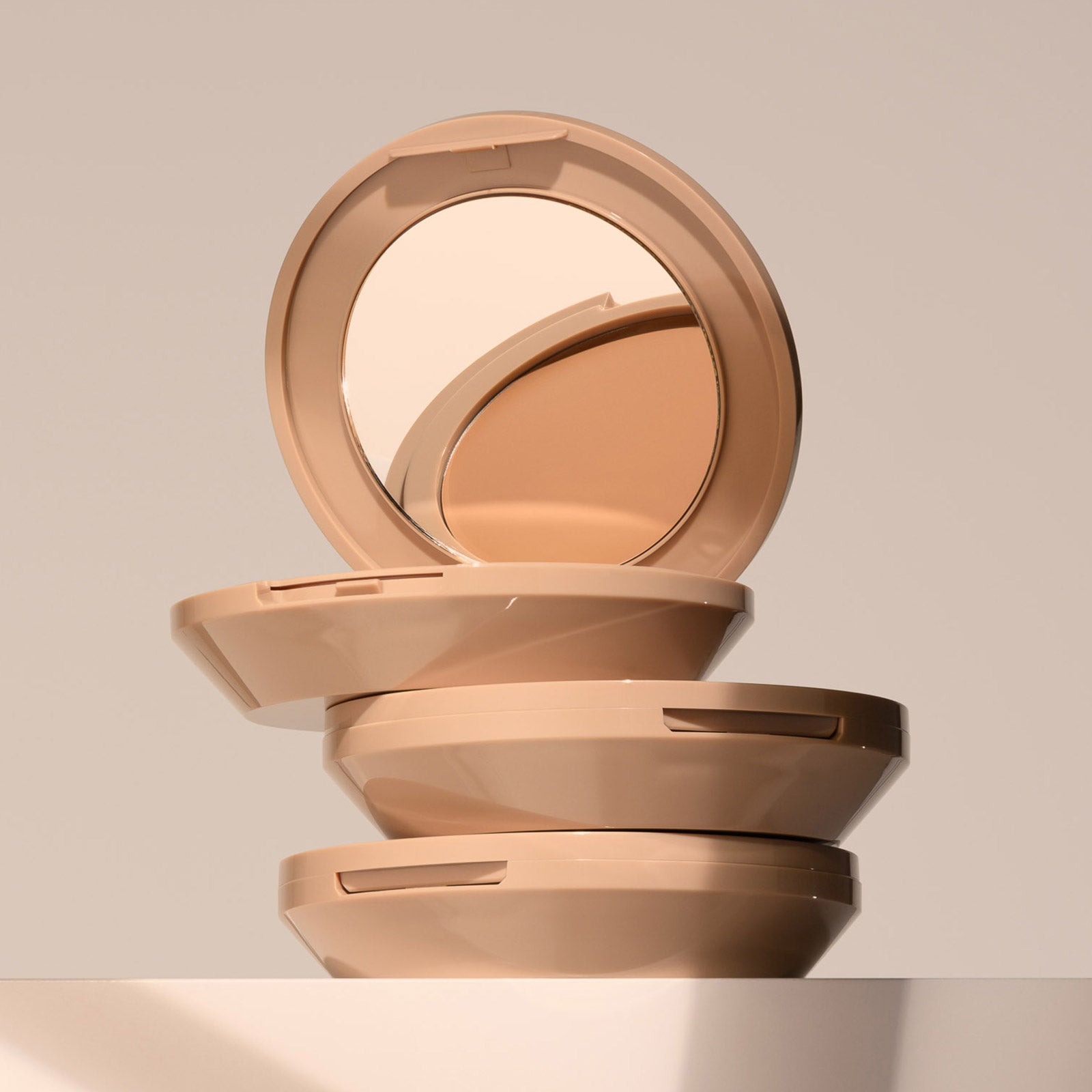 Three FlexShade Foundation by No Makeup Makeup compacts stacked