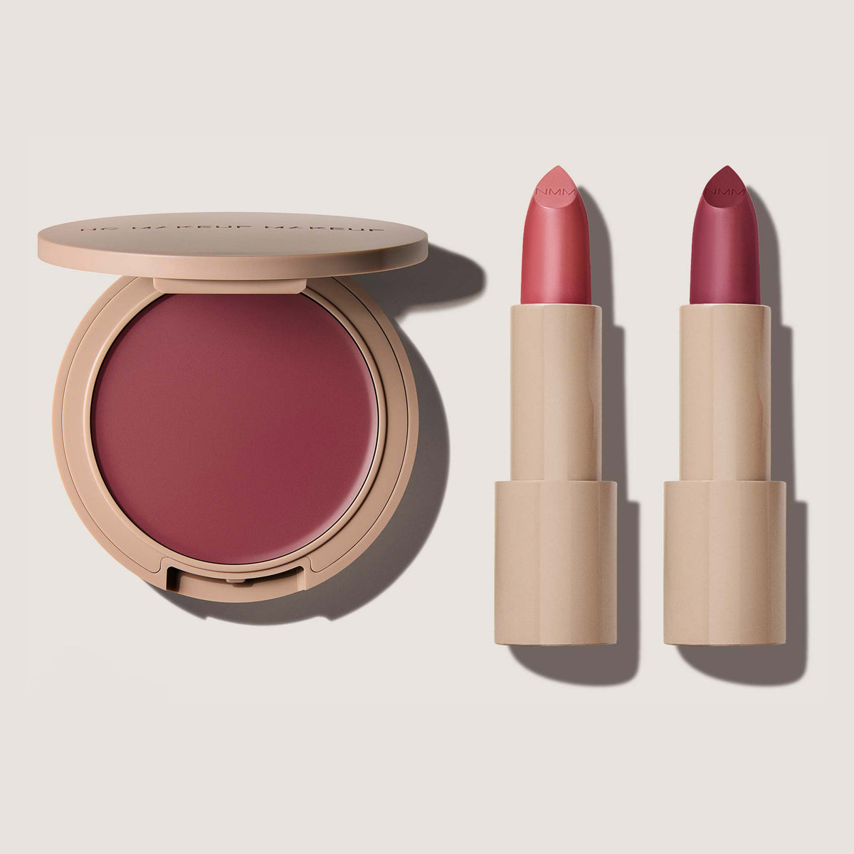 A makeup set featuring a Blush & Lip Color in shade plum and two Classic Creme Lipsticks in plum 01 and plum 02.
