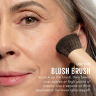 Woman applying plum blush with a brush, text overlaid with instructions