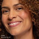 Tanned skin woman wearing Blush & Lip Color in Pink