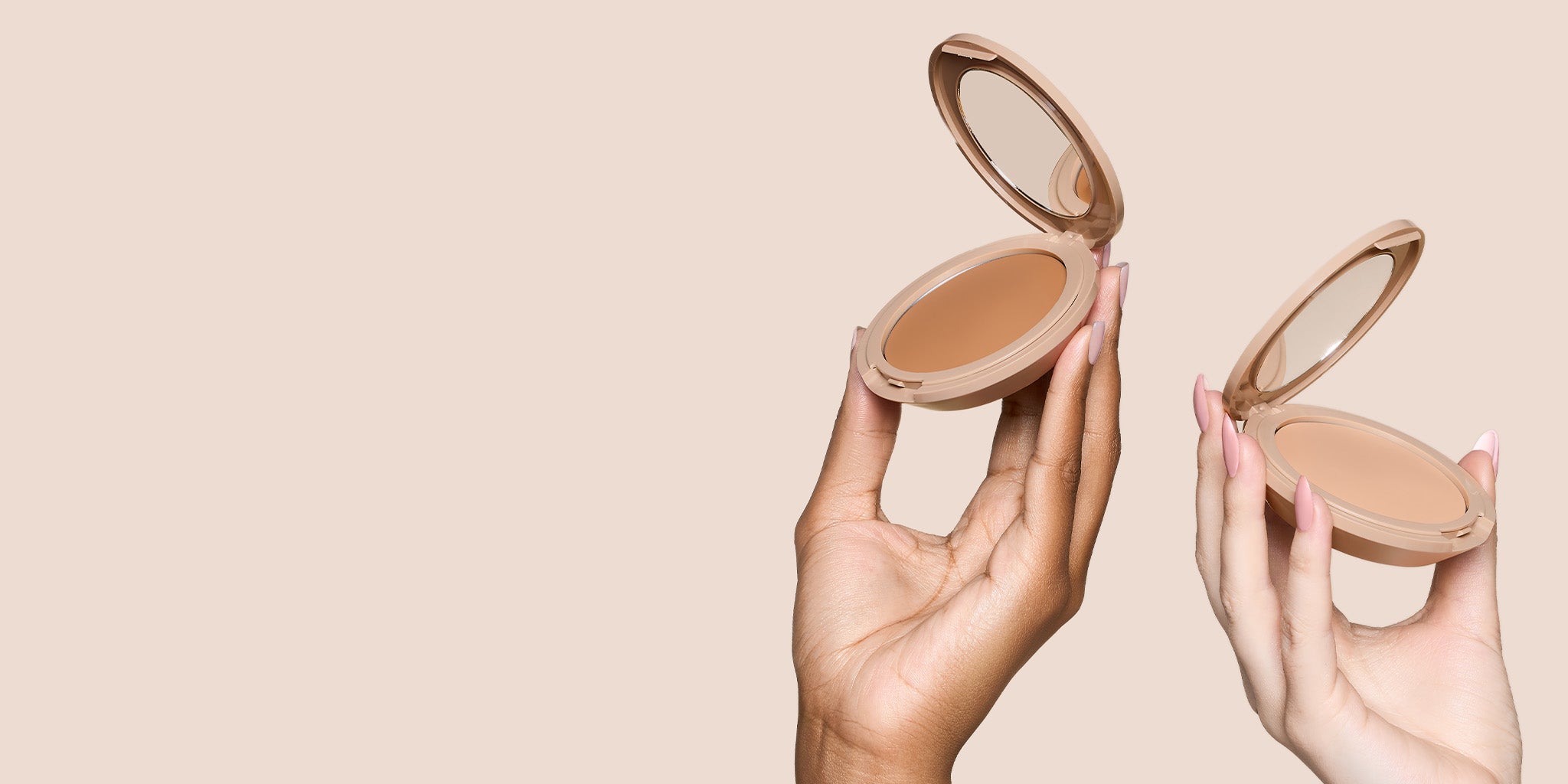 Two hands holding open No Makeup Makeup Foundation compacts