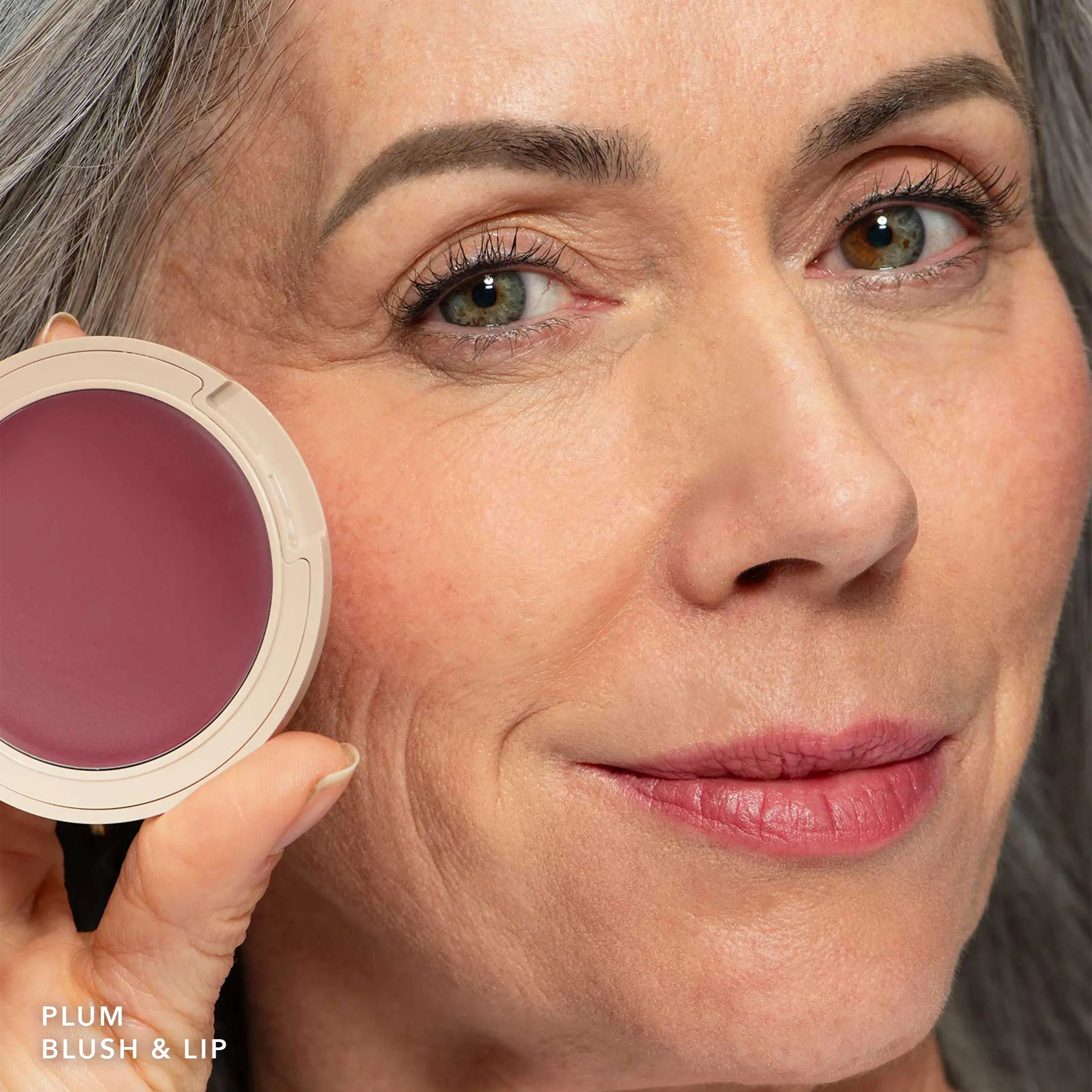 No Makeup Makeup – Close-up of a woman holding a plum blush compact, natural minimal makeup
