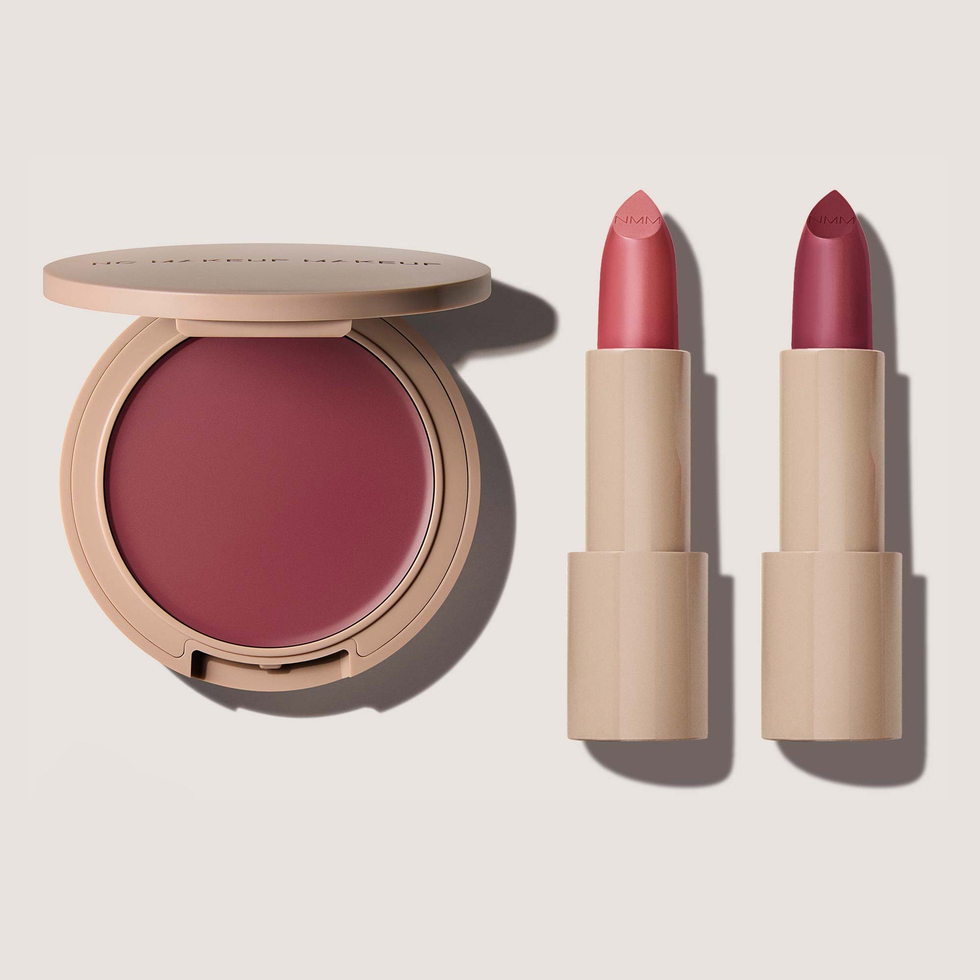 A makeup set featuring a Blush & Lip Color in shade plum and two Classic Creme Lipsticks in plum 01 and plum 02.